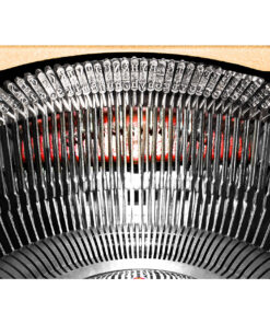 Close-up of a vintage typewriter's type bars forming a semicircle with metallic slugs winding around the mechanism