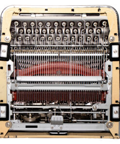 Close-up of an exposed vintage mechanical typewriter showing typebars, ribbon, and gears inside