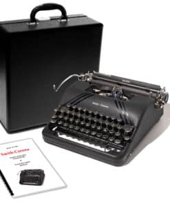 Portable Smith-Corona vintage typewriter with its black carrying case and instruction sheets nearby.