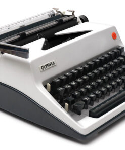 Close-up of a vintage Olympia typewriter showing keys and metal carriage, gray body with black keys.