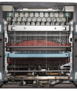 Close-up of a dot-matrix printer head with many pins inside the printer.