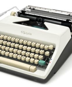Vintage typewriter with cream keys and metal carriage, viewed from a low angle on a white background, showing the keyboard and ribbon area.
