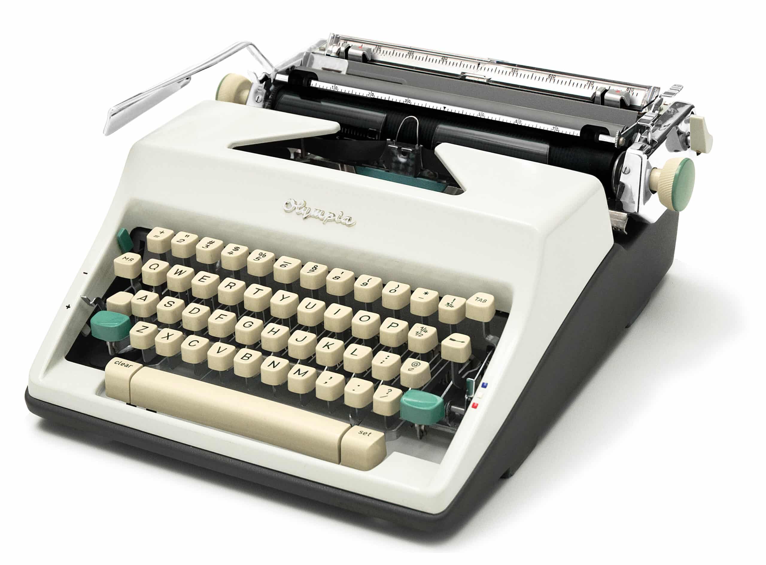 Vintage typewriter with cream keys and metal carriage, viewed from a low angle on a white background, showing the keyboard and ribbon area.