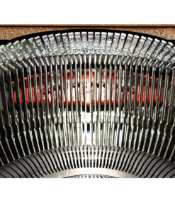 Close-up of curved metal turbine blades arranged in a circular arc, with a red-lit background behind them