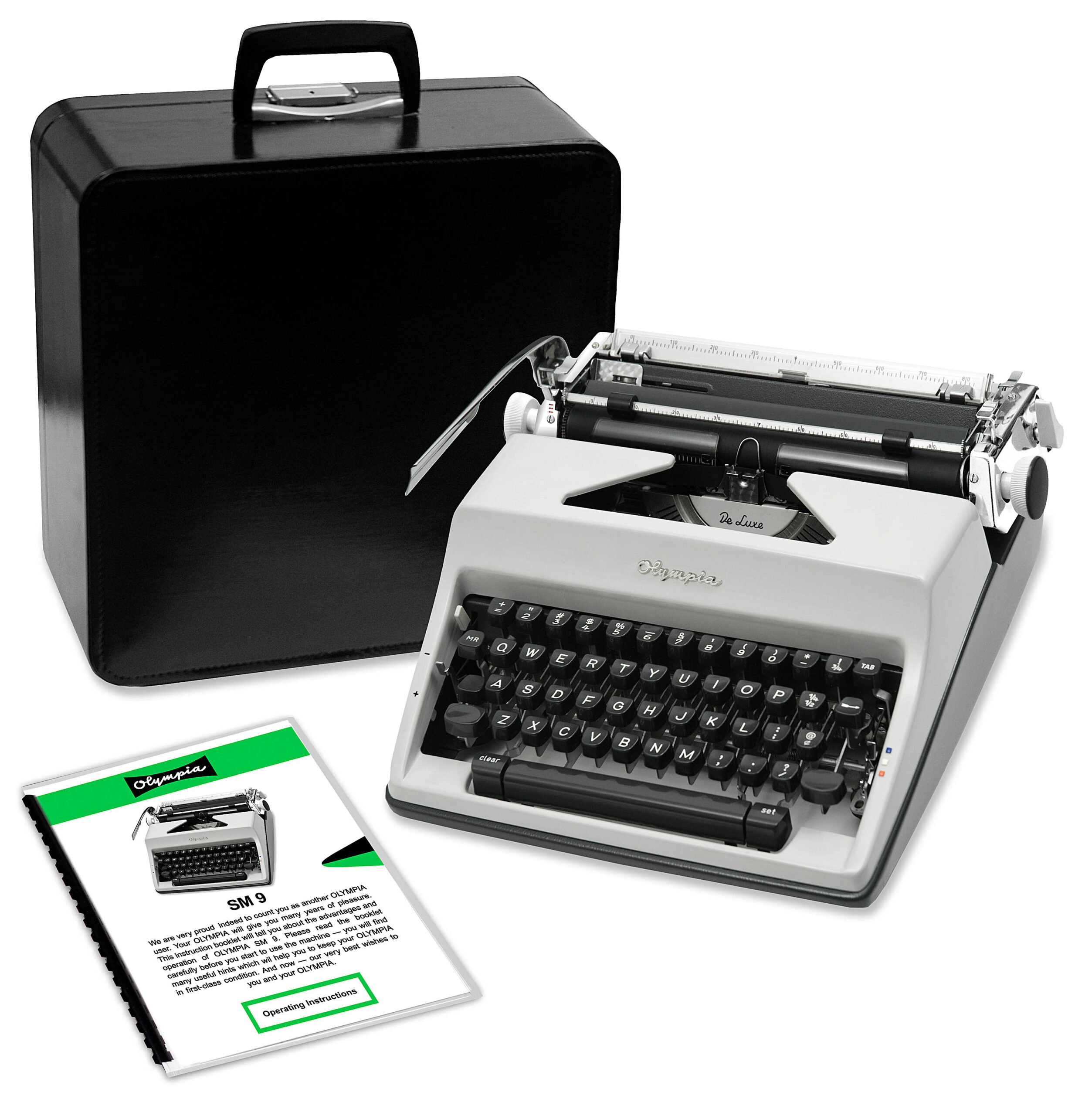 Vintage Olympia manual typewriter with open case and instruction sheets laid nearby.