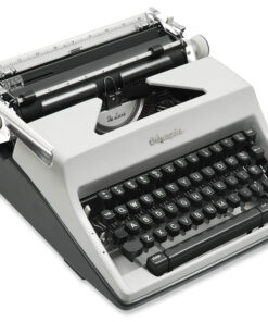 Close-up of a vintage De Luxe typewriter showing the typing mechanism, ribbon area, and row of black keys.