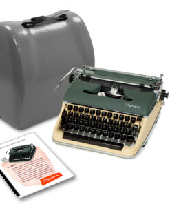Old green manual typewriter beside a large gray hard-shell suitcase, with instruction sheets nearby.