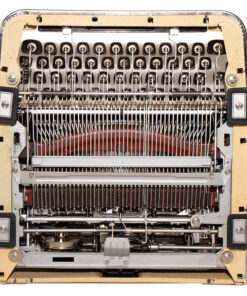 Close-up of the inner mechanism of a vintage typewriter, showing type hammers, ink ribbons, and carriage components.
