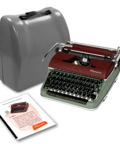 Vintage Olympia typewriter beside its gray carrying case with an instruction booklet nearby.