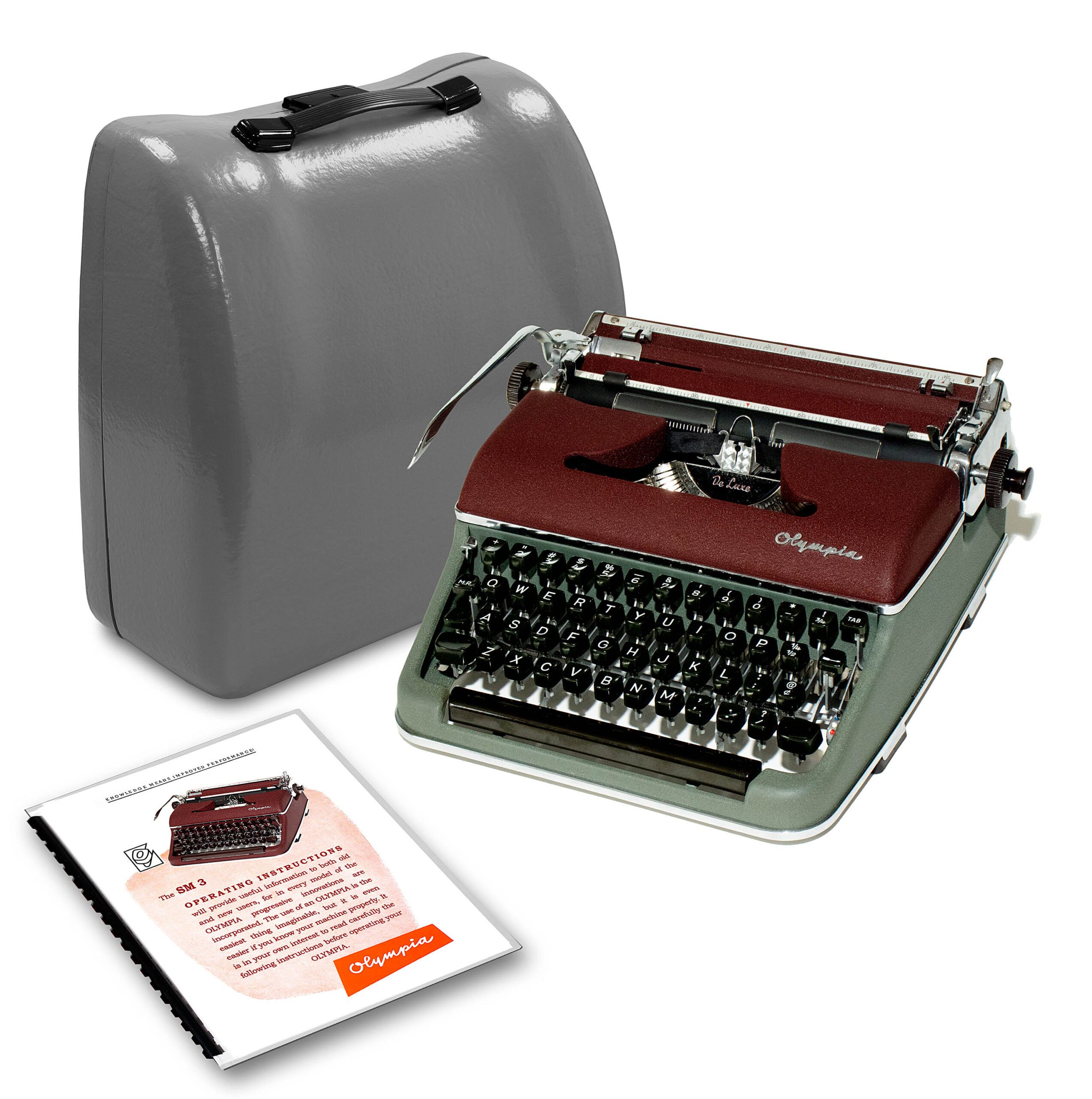 Vintage Olympia typewriter beside its gray carrying case with an instruction booklet nearby.