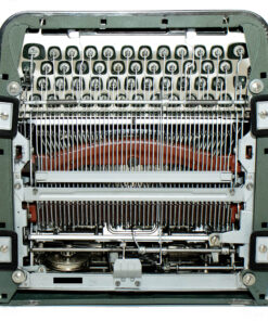 Close-up of a vintage sewing machine interior with many needles and thread guides.