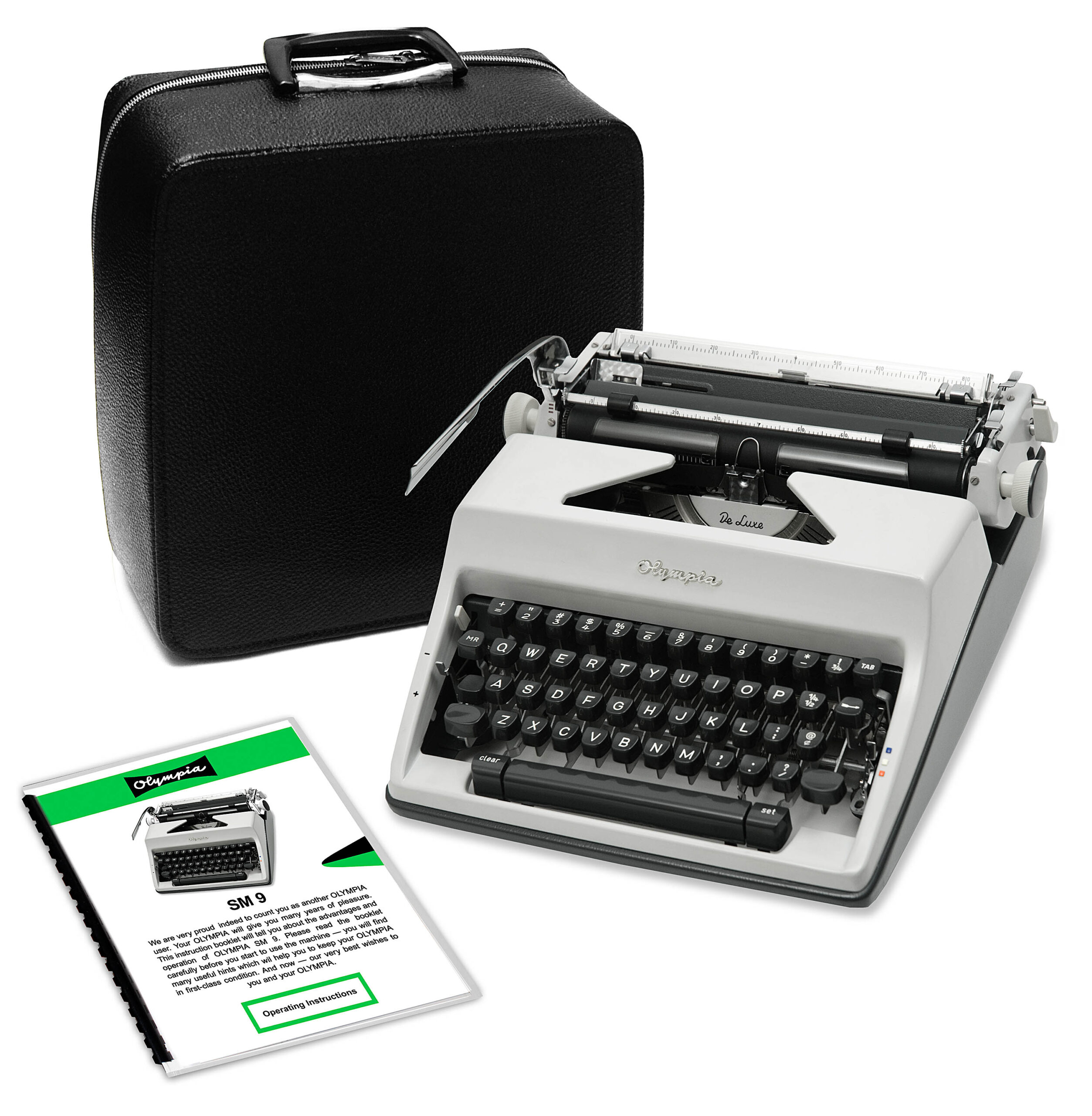 Vintage Olympia typewriter beside a black leather carrying case and instruction booklets.