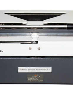 Top-down view of a white Olympia typewriter showing internal roller and metal components, branding visible on the front plate