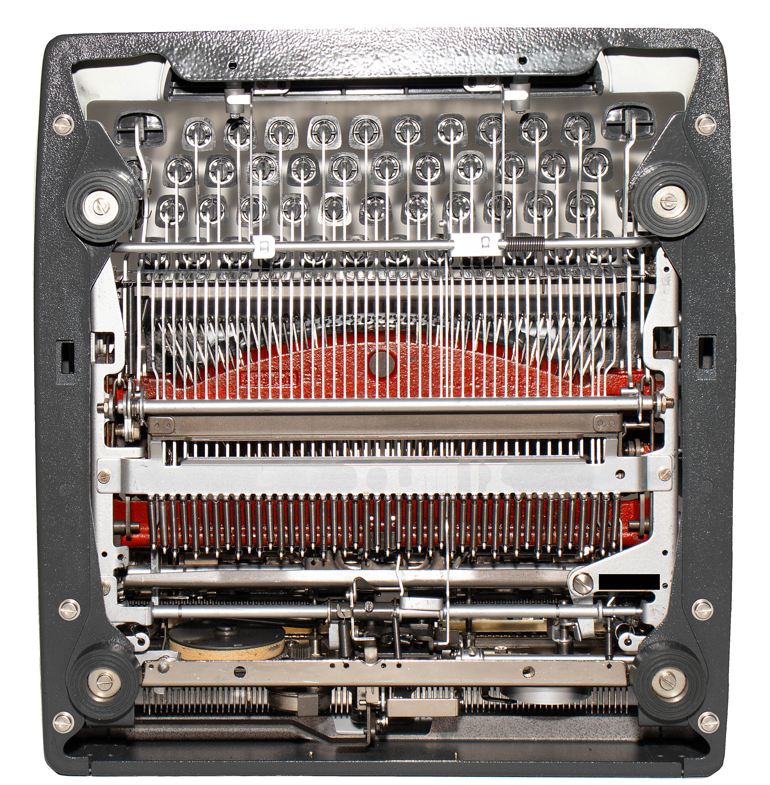 Close-up of a vintage typewriter’s inner mechanism with typebars and ribbon visible inside the frame.