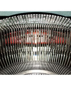 Close-up of an old typewriter showing the curved type bars and slugs above the ribbon area.