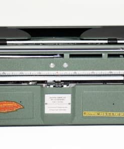 Green vintage Olympia typewriter with metal carriage and stickers on the front panel, photographed from the side.