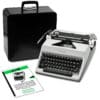 Vintage Olympia typewriter with its open case and accompanying instruction sheets in view, black keys and metal mechanisms visible
