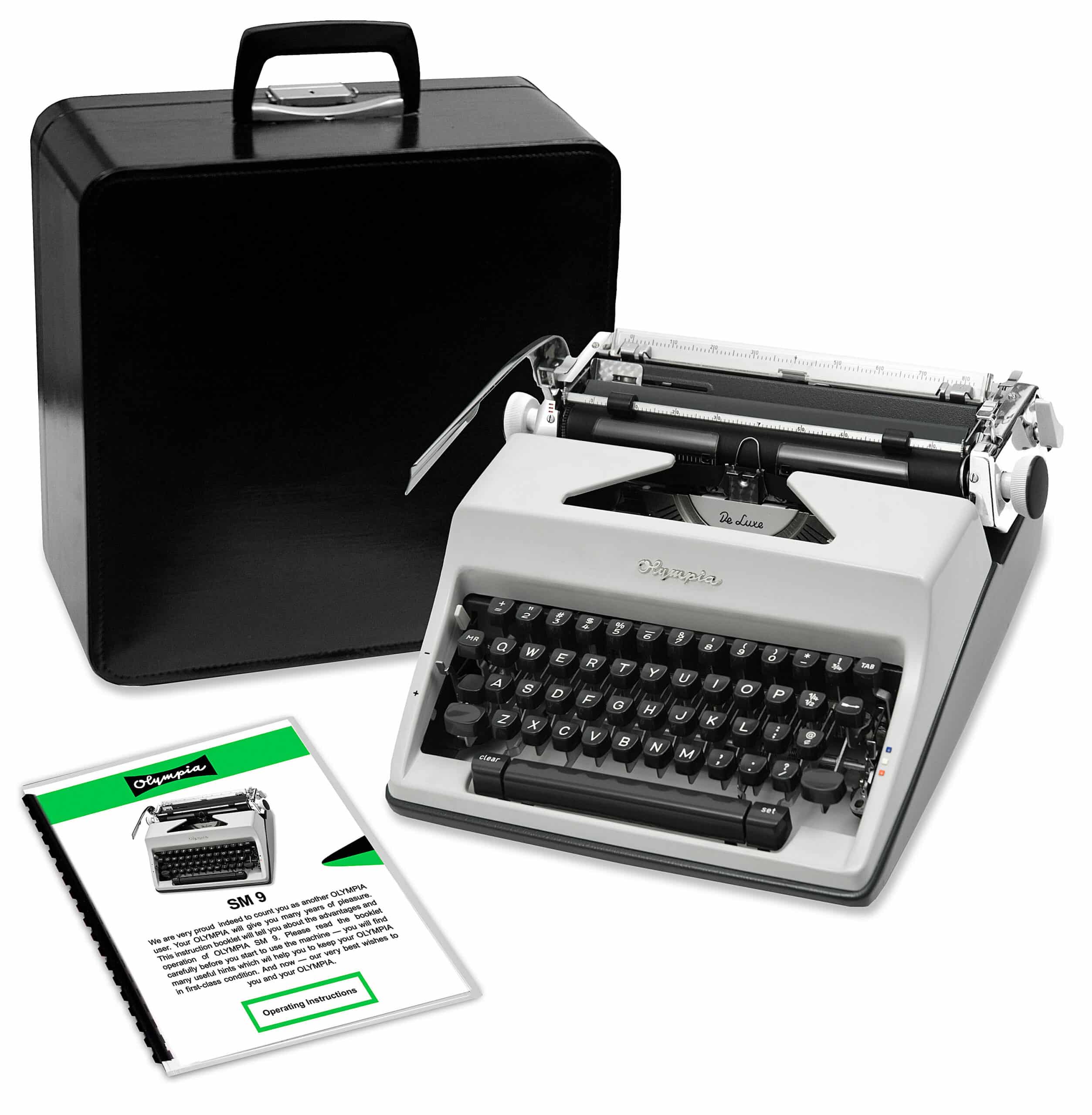 Vintage Olympia typewriter with its open case and accompanying instruction sheets in view, black keys and metal mechanisms visible