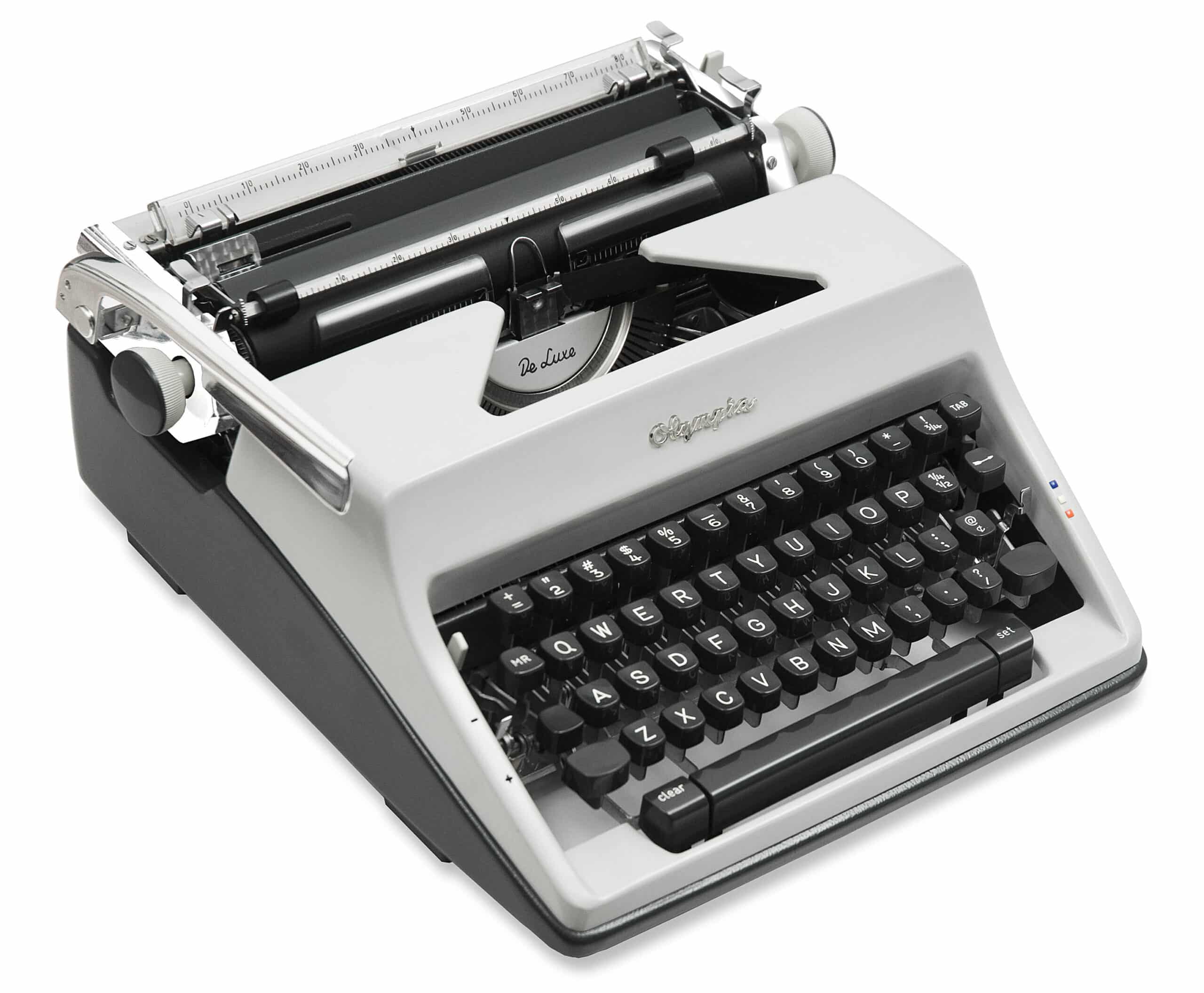 Close-up of a vintage gray typewriter showing black keyboard keys and metal carriage.