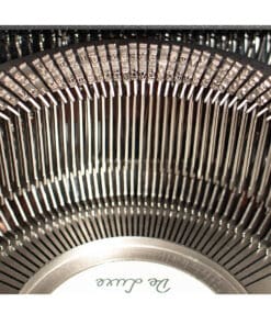 Close-up of vintage typewriter type slugs arranged in a circular pattern inside the machine