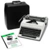 Portable black Olympia typewriter with open keyboard and visible typebars beside a black leather case and instruction sheets.