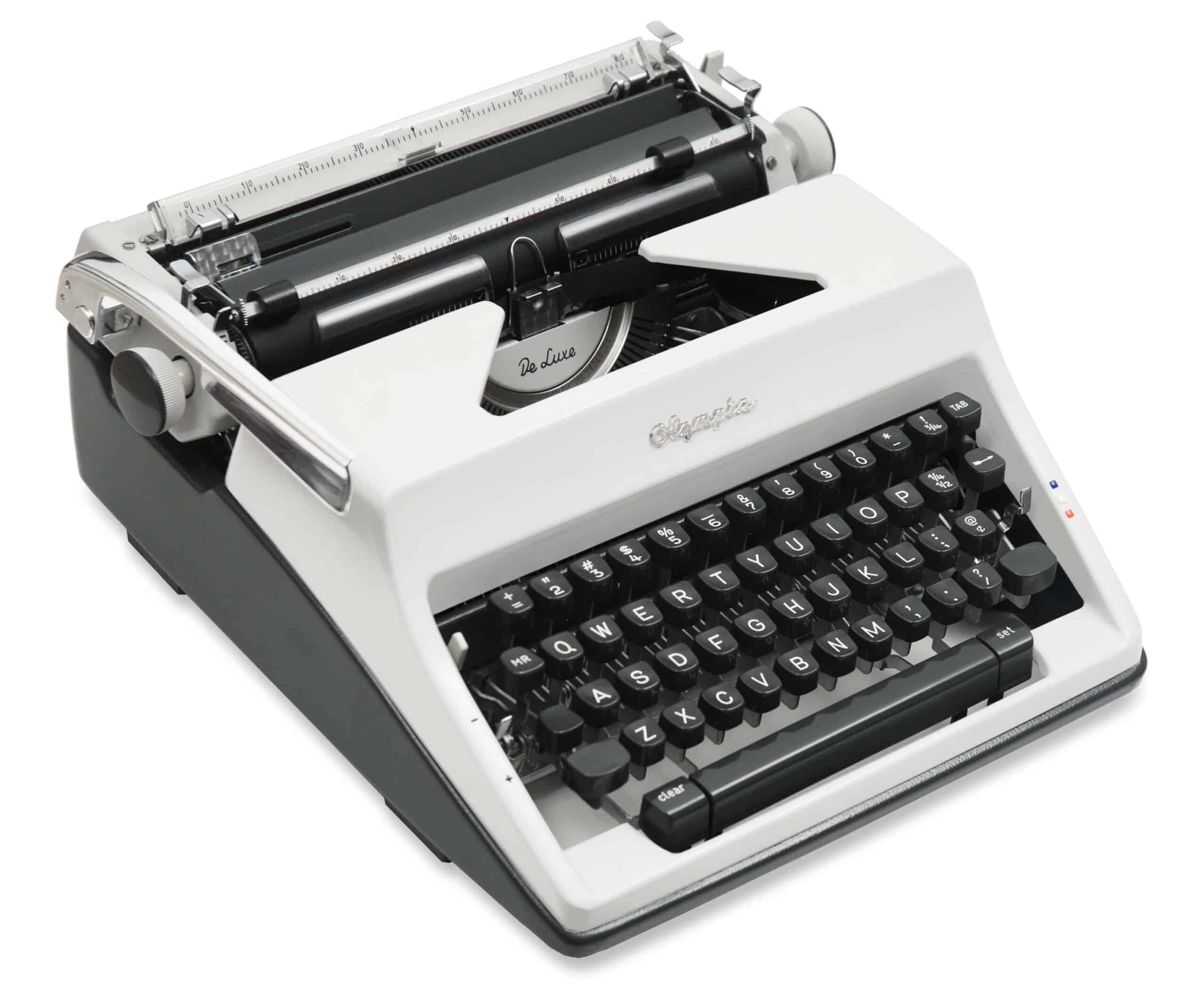 Close-up of a vintage typewriter with its keys and carriage visible on a light background.