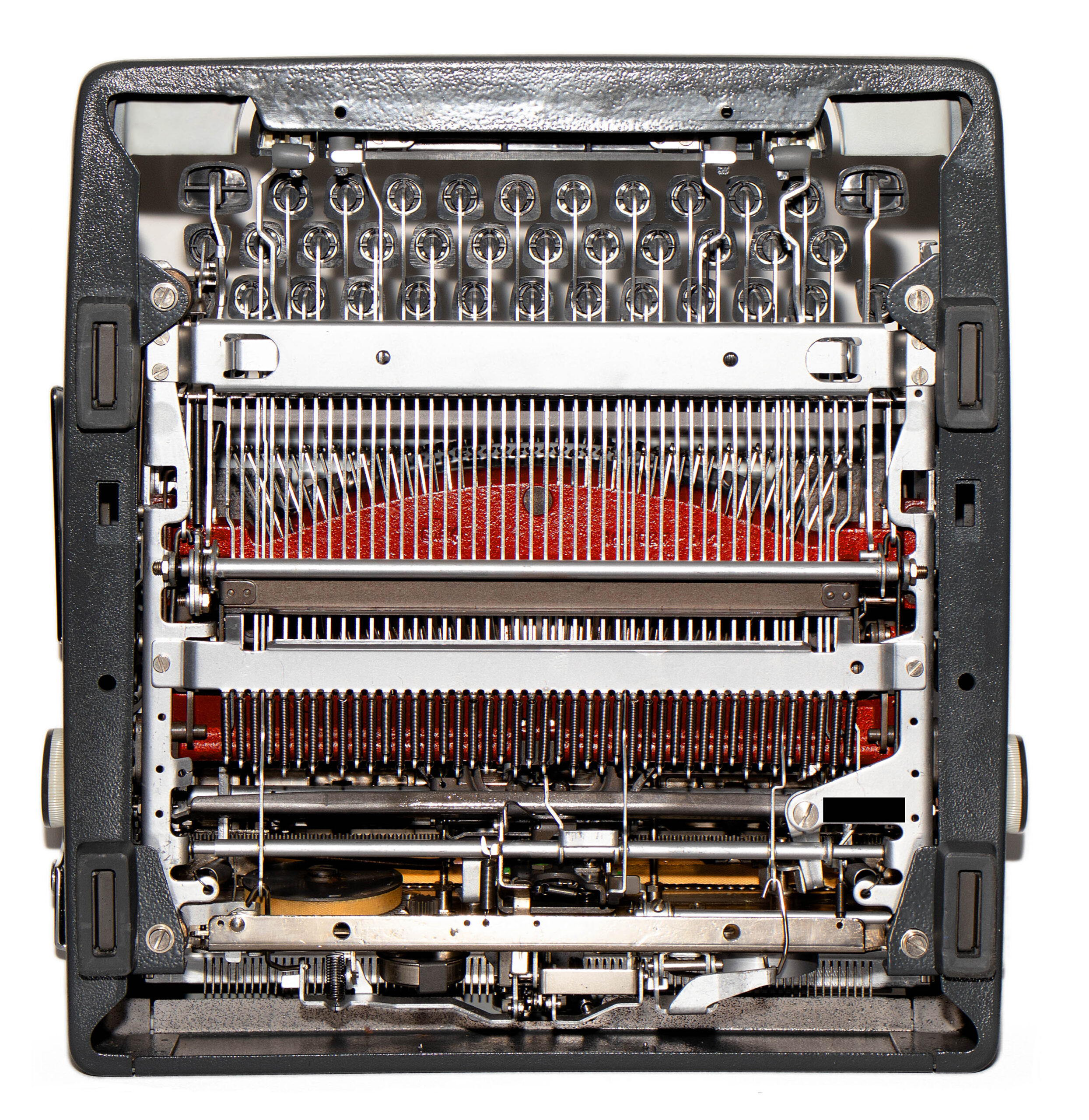 Close-up of an old mechanical typewriter's inner typing mechanism with type bars, ribbon, and carriage parts