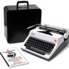 Old Olympia typewriter with a black carrying case and scattered instruction manuals on a white background (informative image).