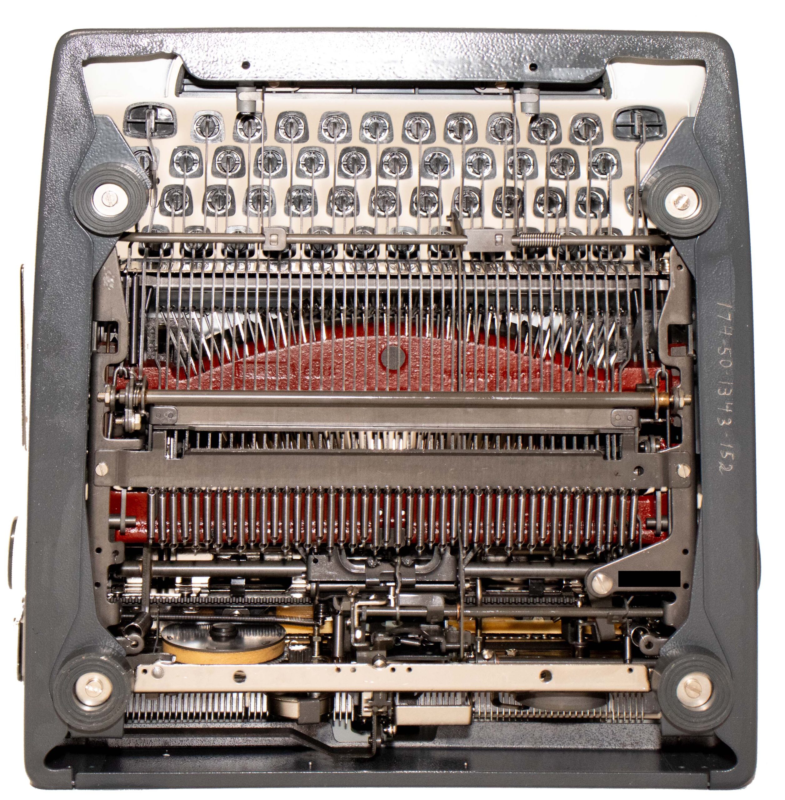 Close-up of a vintage typewriter's inner mechanism, showing keys, type bars, ribbon, and alignment wheels in metallic and gray tones.