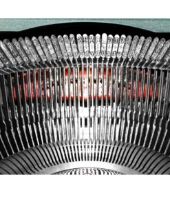 Close-up of a vintage typewriter’s inner mechanism, showing curved rows of metal type slugs and type hammers with red accents in the background