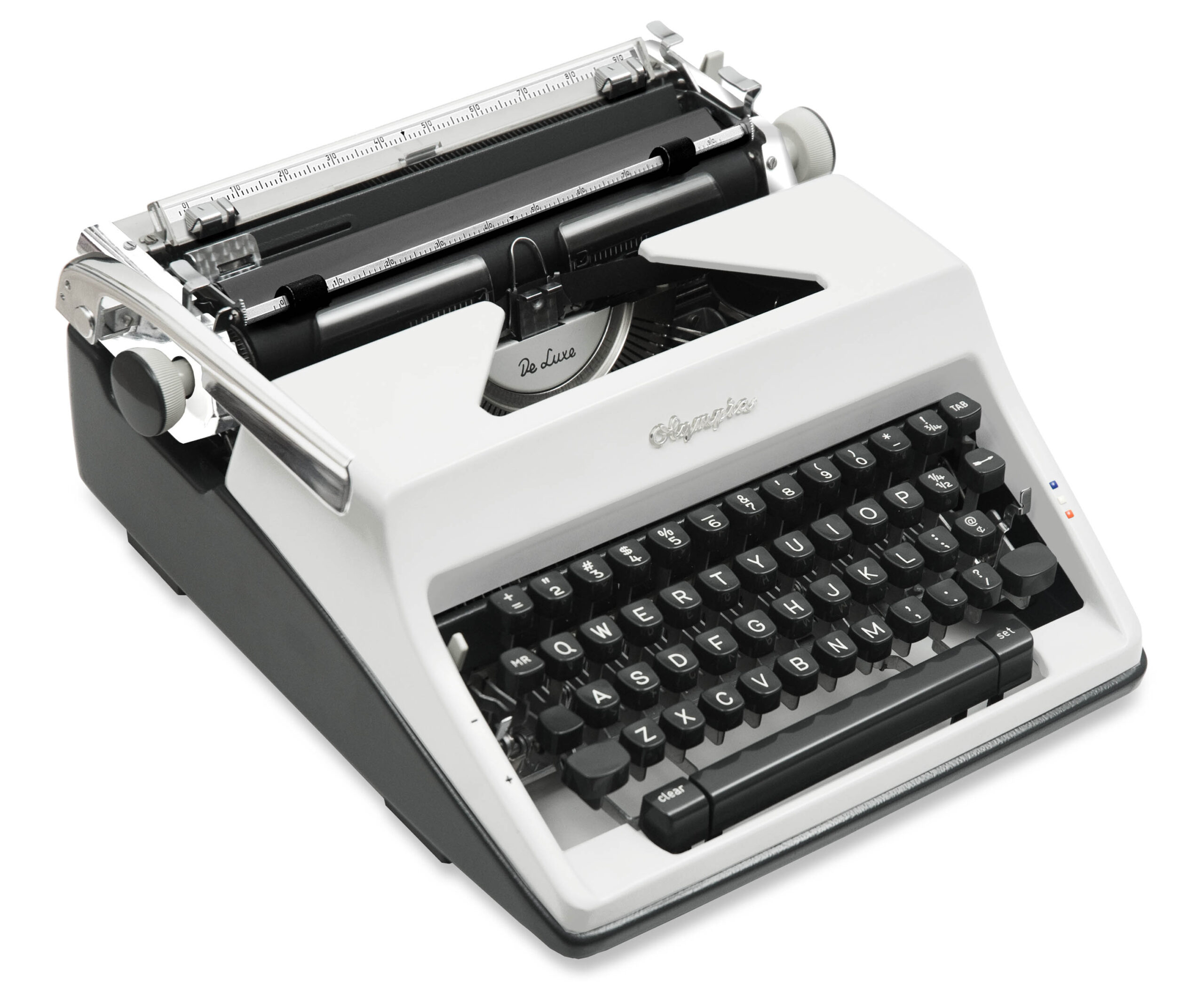 Top-down view of a vintage typewriter with a gray body and black round keys, showing the platen and type bars.