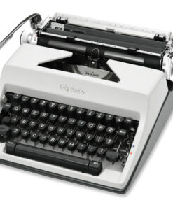 Vintage white Olympia De Luxe typewriter seen from a top-left angle, showing the keyboard and type mechanism.