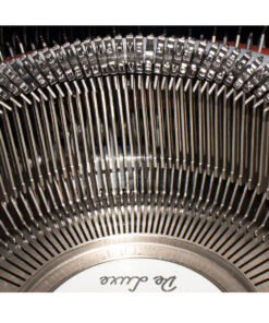 Close-up of a vintage typewriter's type bars and metal type slugs inside the machine.