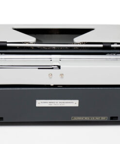 Top-front view of a vintage Olympia typewriter with visible type mechanism, white body and dark base.
