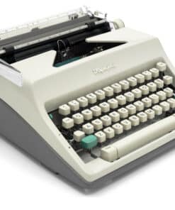 Vintage Olympia typewriter with cream body and round ivory keys, photographed from a side angle.