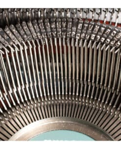 Close-up of a circular arc of metal pins in a large mechanical device, showing precise, repeated components.