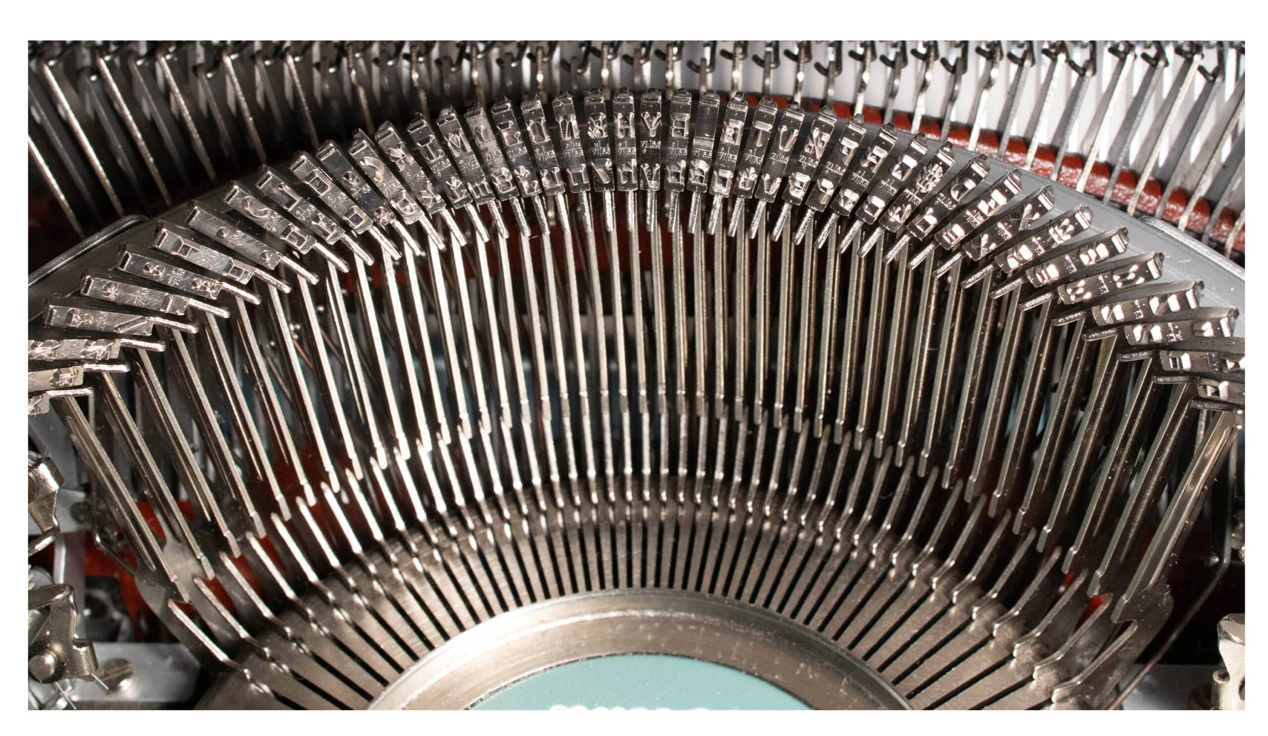 Close-up of a circular arc of metal pins in a large mechanical device, showing precise, repeated components.