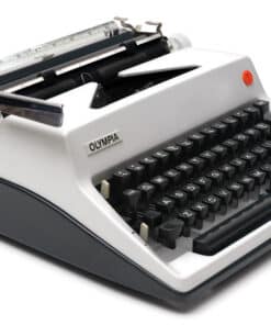 Close-up of a vintage Olympia typewriter showing keys and typebars on a white body.