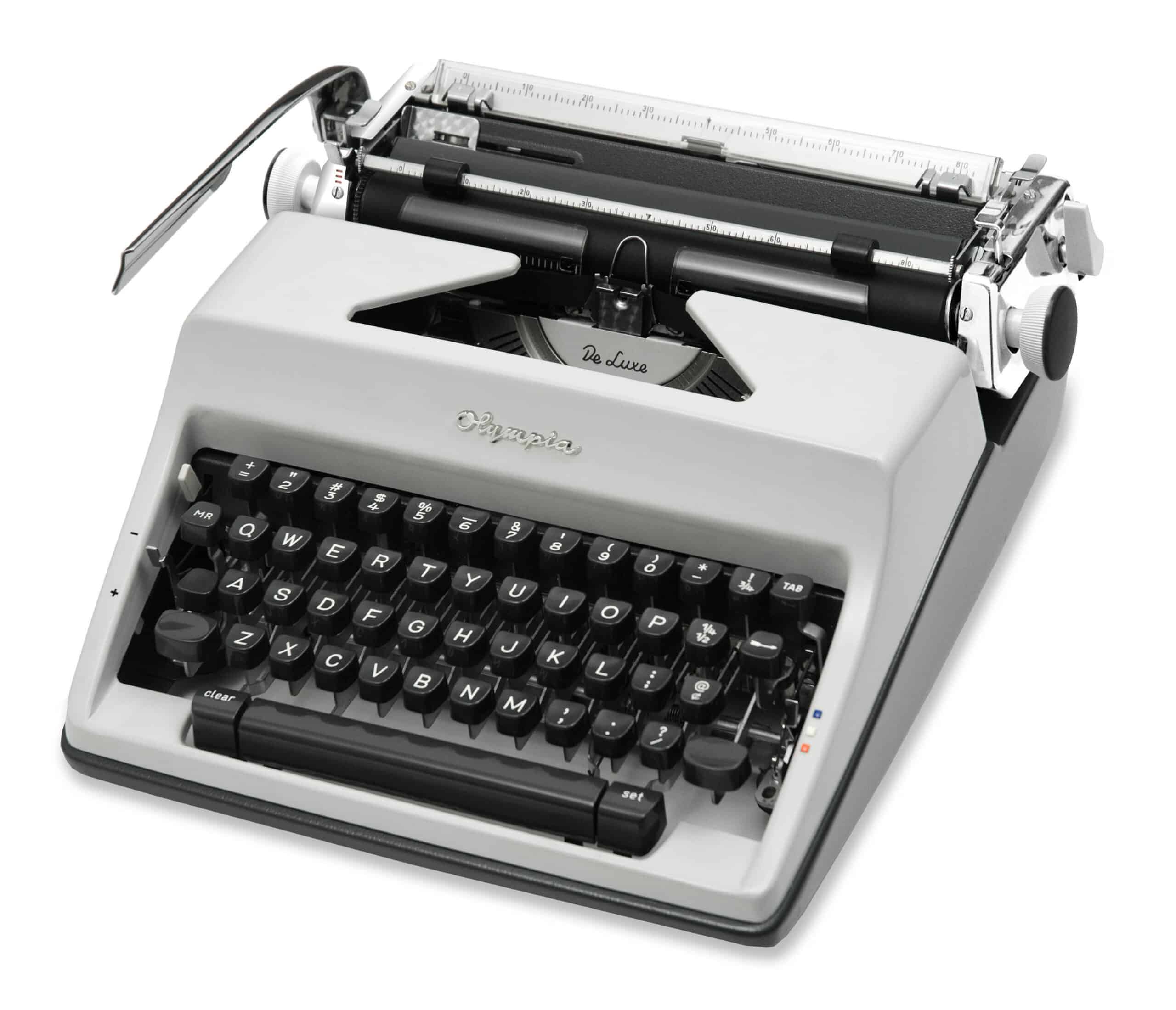 Vintage gray manual typewriter with black round keys, angled to show the carriage and return lever
